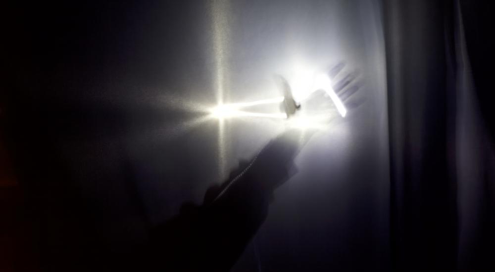 hand glowing in a ray of light