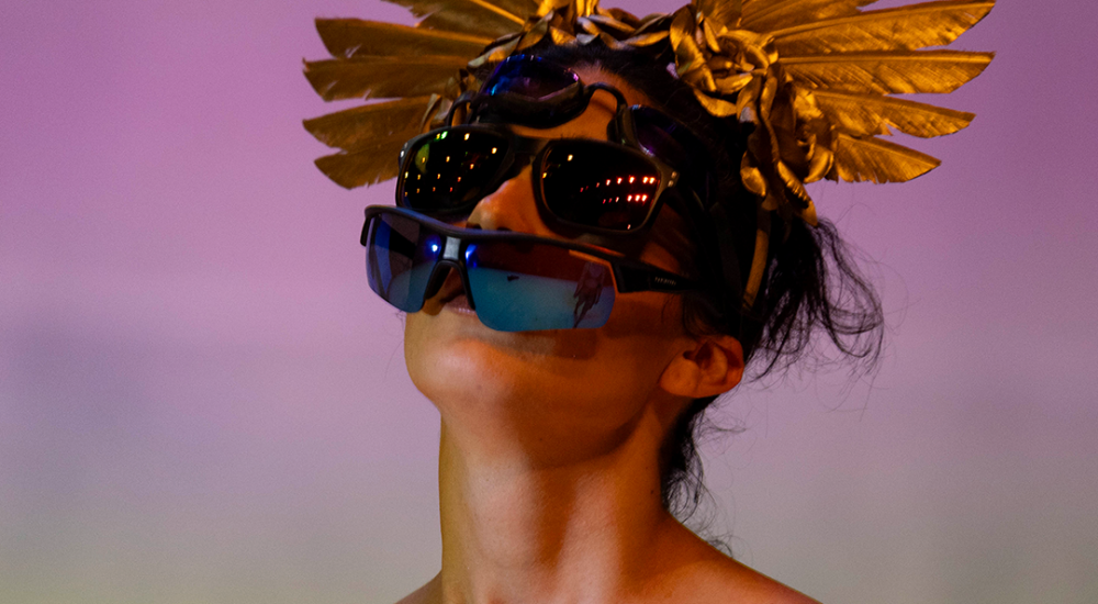 a person with a golden bird mask