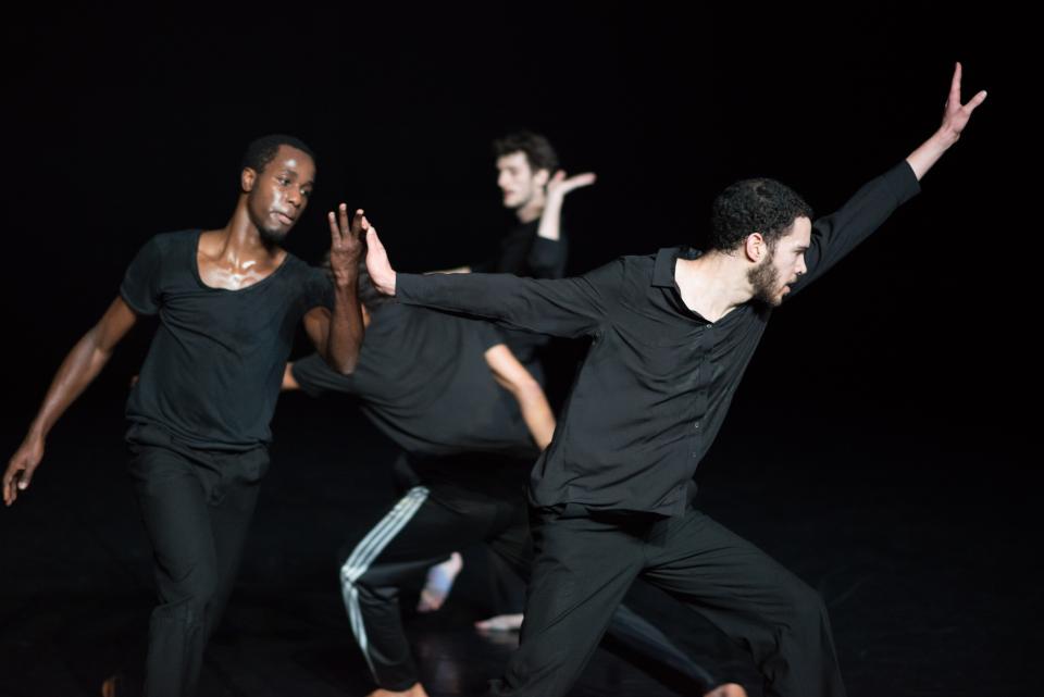 4 male dancers wearing black clothes
