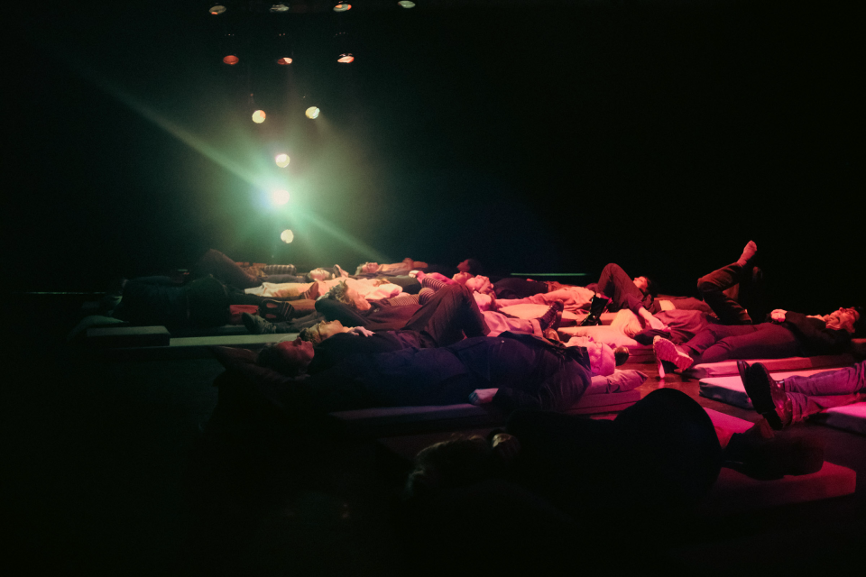 Spectators lying down watching the performance