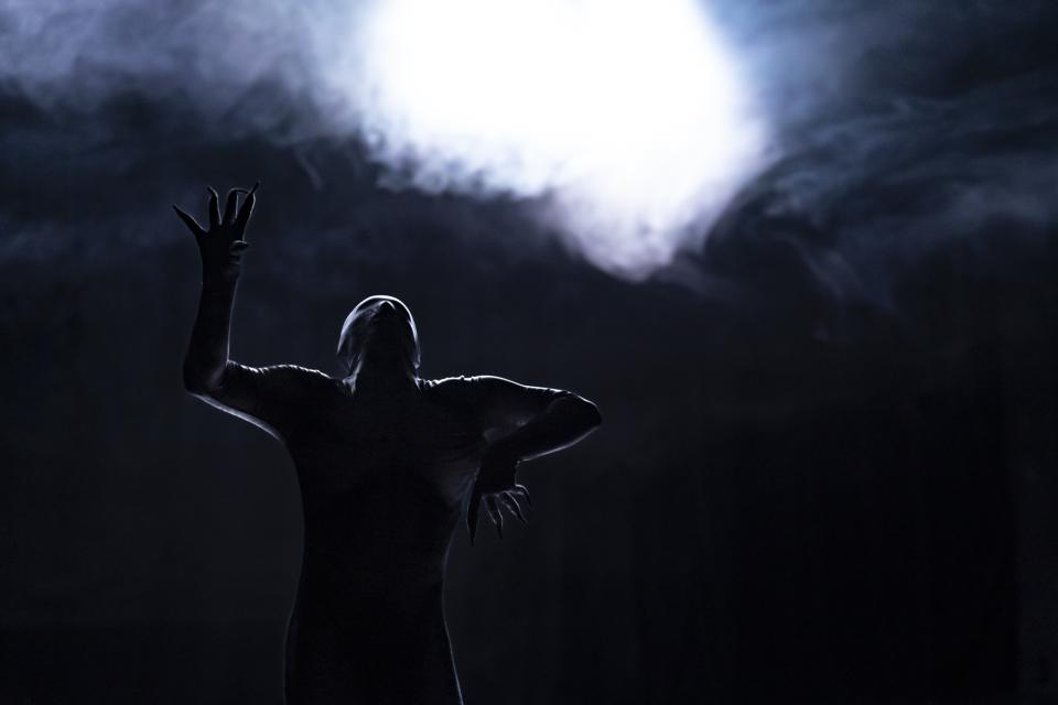 A dancer in a skeleton bodysuit