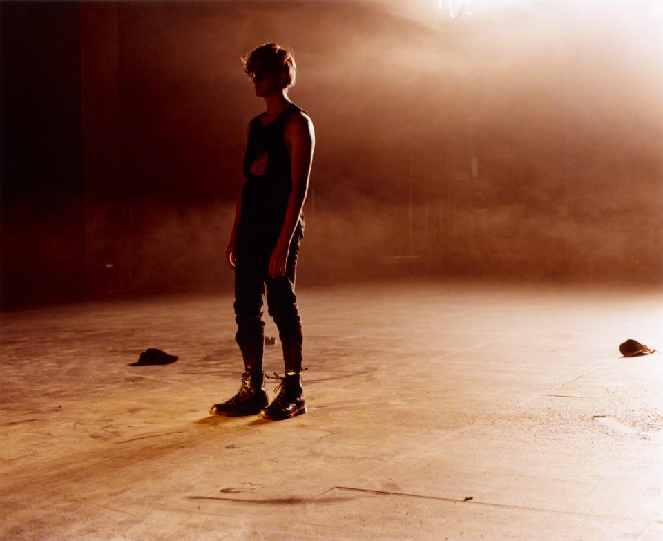 A person standing in what looks like a desolate landscape