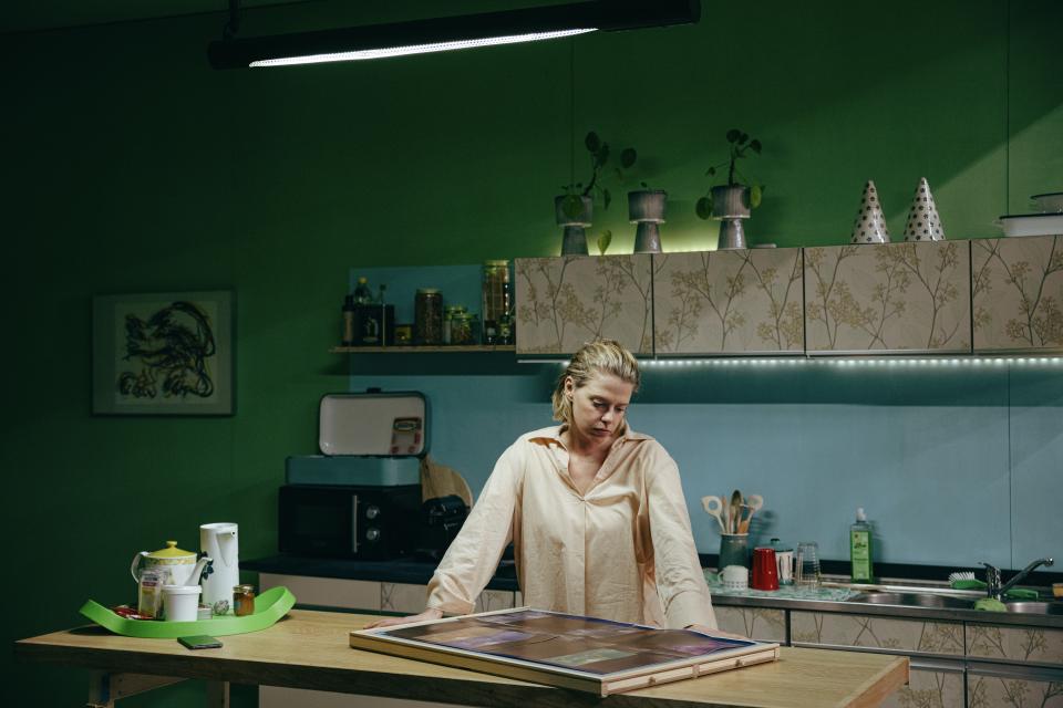 A person standing at a kitchen counter