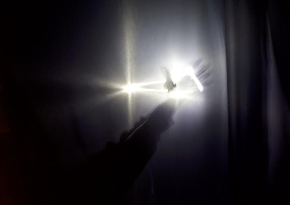 hand glowing in a ray of light