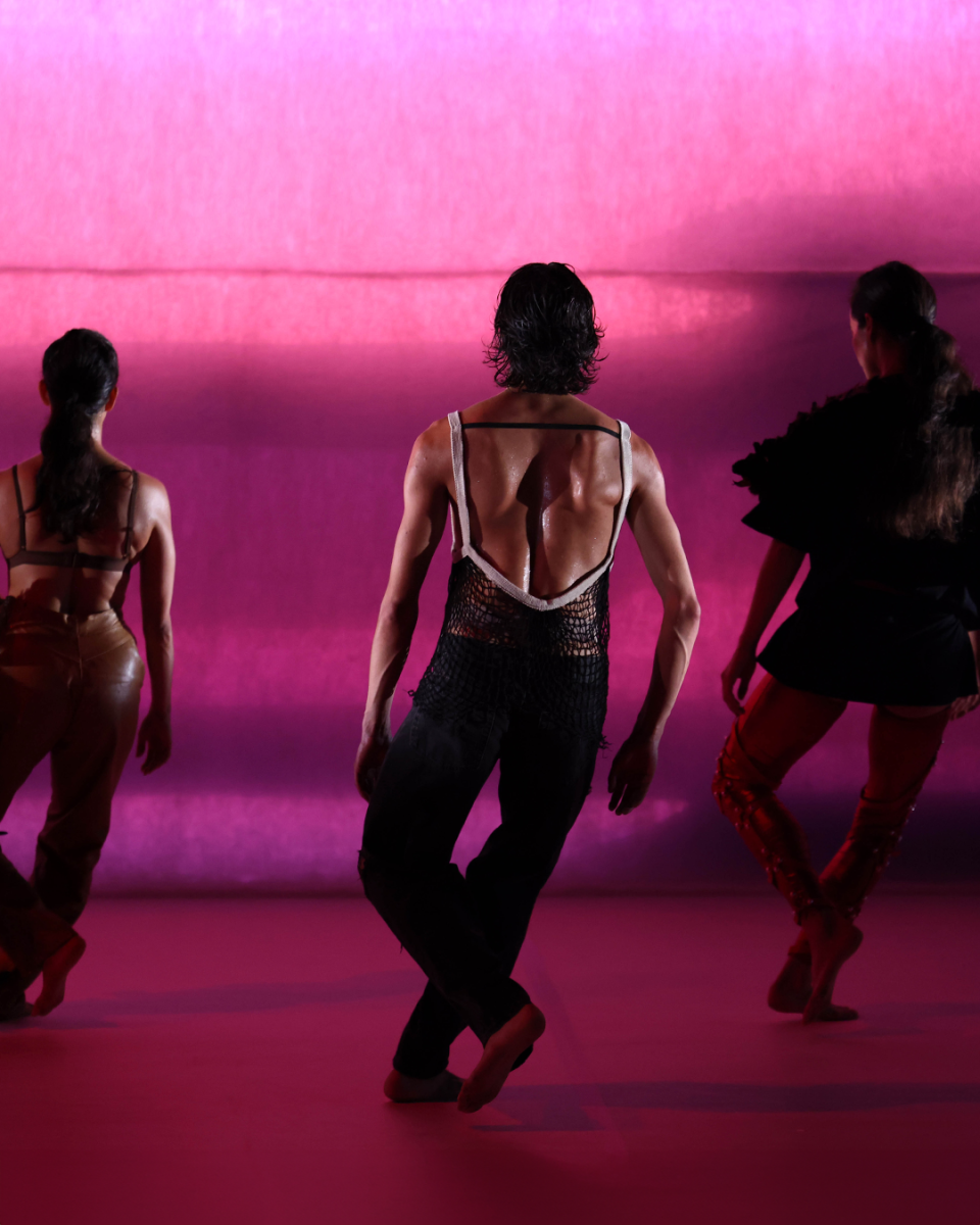 dancers in front of a pink background