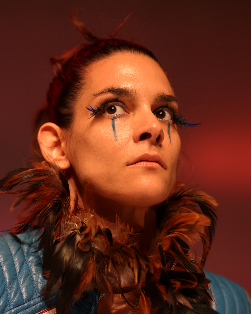 a person looking serious with green stripes under the eyes