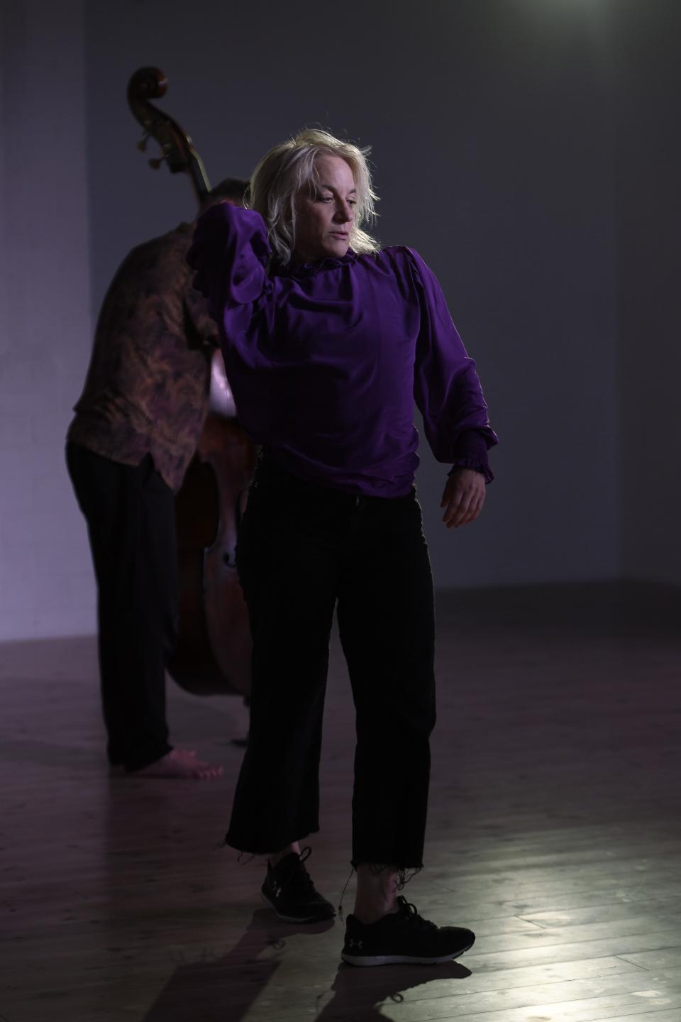 performer with double bass player on the background